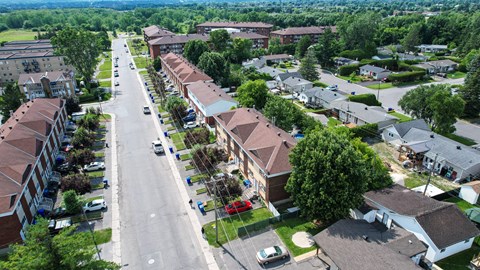 A street view of a residential area with houses on both sides.