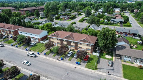 A residential area with houses and parked cars.