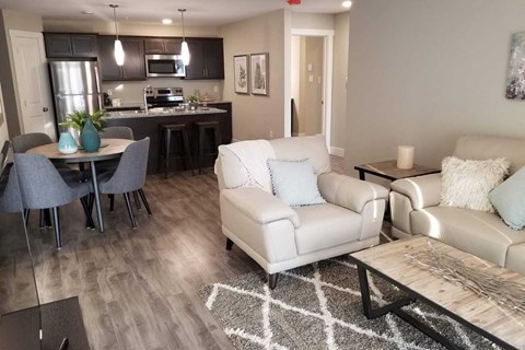 A modern living room with a dining table and chairs.
