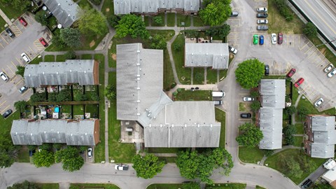 A bird's eye view of a residential area with houses and cars.