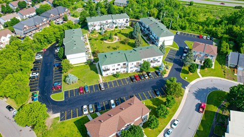 A bird's eye view of a residential area with houses and cars.