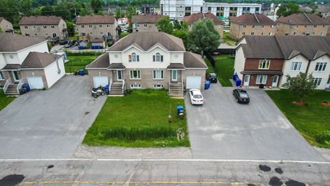 A residential area with houses and cars.
