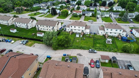 A residential area with houses and cars.