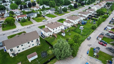 A residential area with houses and cars.
