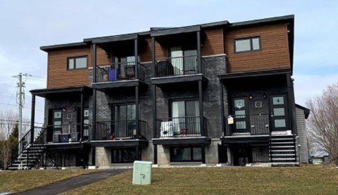 A large multi-story building with balconies and stairs.