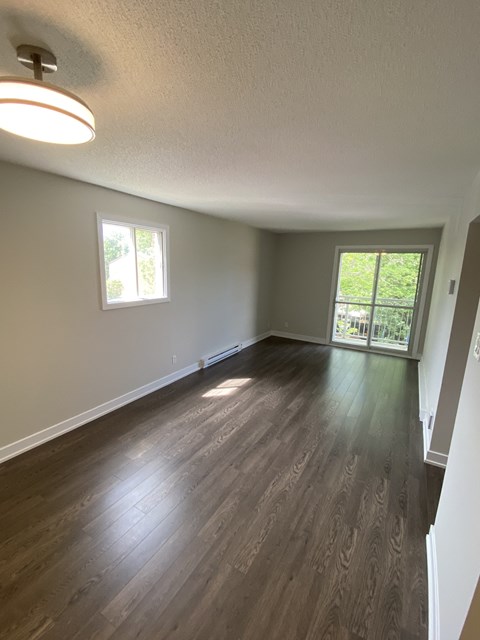 A room with wooden floors and a window.