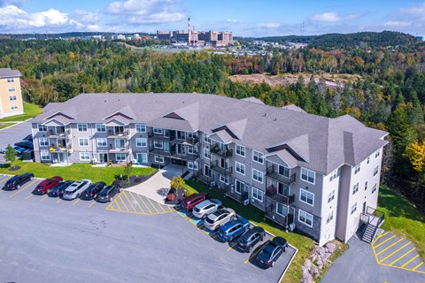 A large building with a parking lot in front of it.