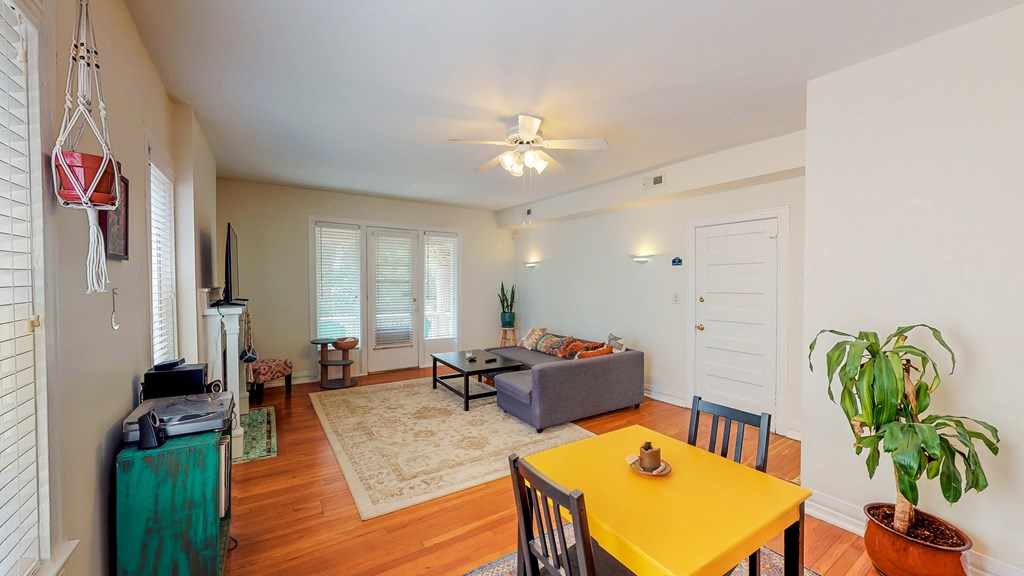 a living room with a yellow table and a couch