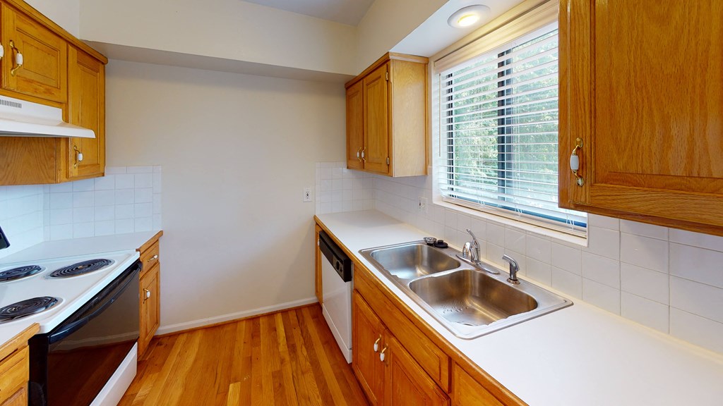 an empty kitchen with a sink and a window