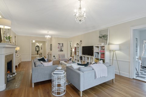 A living room with a grey couch and a white coffee table.