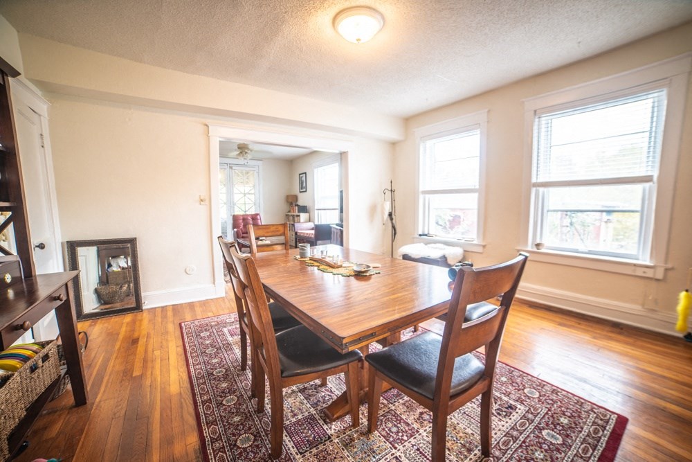an image of a dining room with a wooden table and chairs