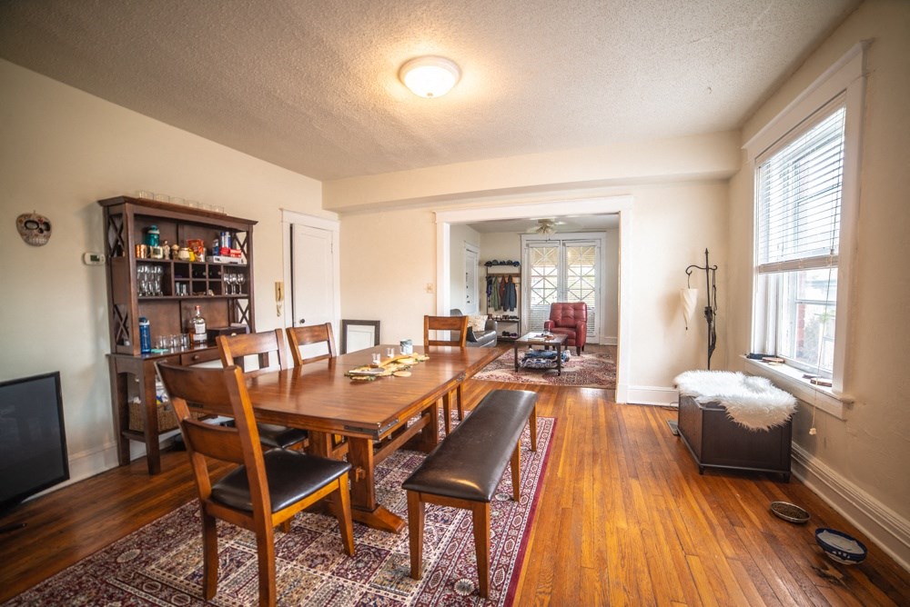 the dining room and living room of a home with a large wooden table and chairs