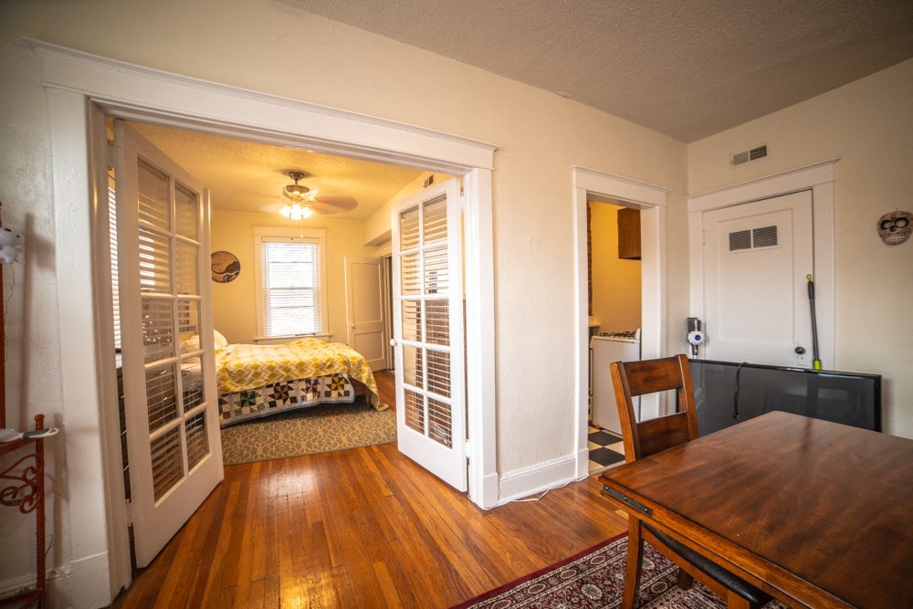 a bedroom with a bed and a dining room table