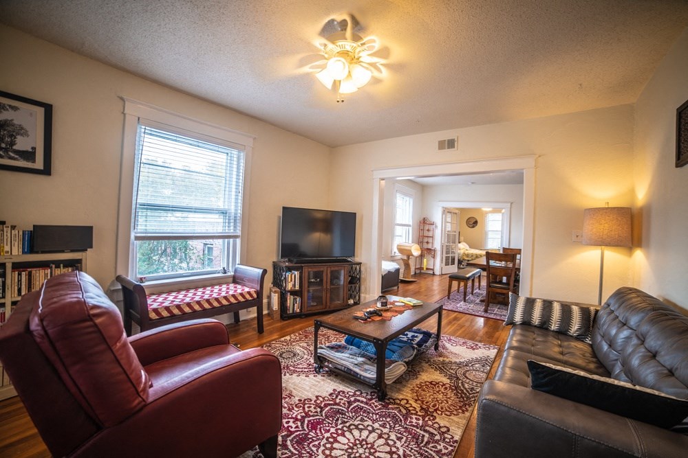 a living room with leather furniture and a tv