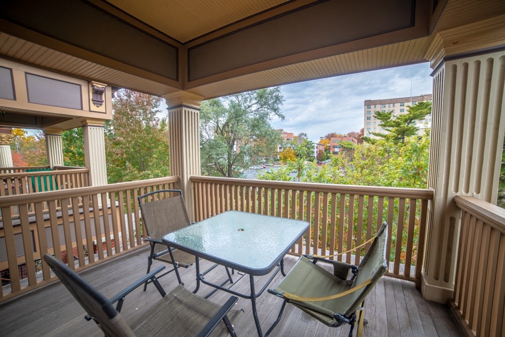 a patio with a table and chairs on a balcony