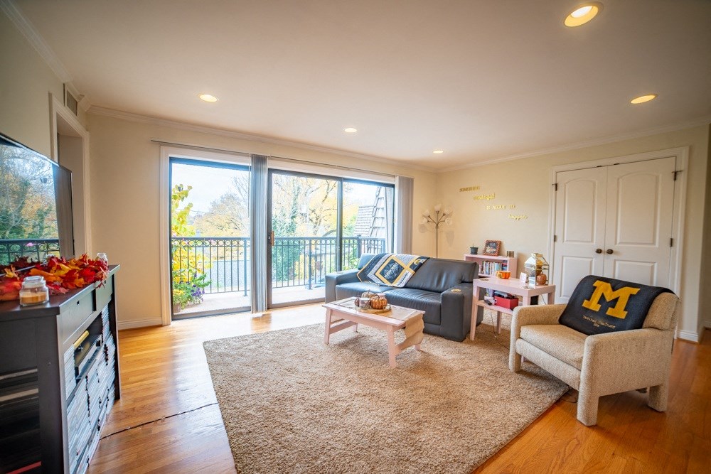 a living room with a couch and a chair and a tv