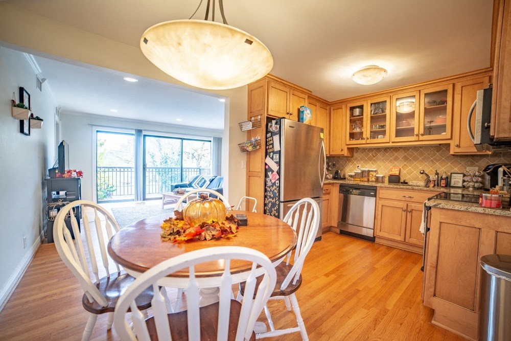 a kitchen with wooden cabinets and a table with chairs