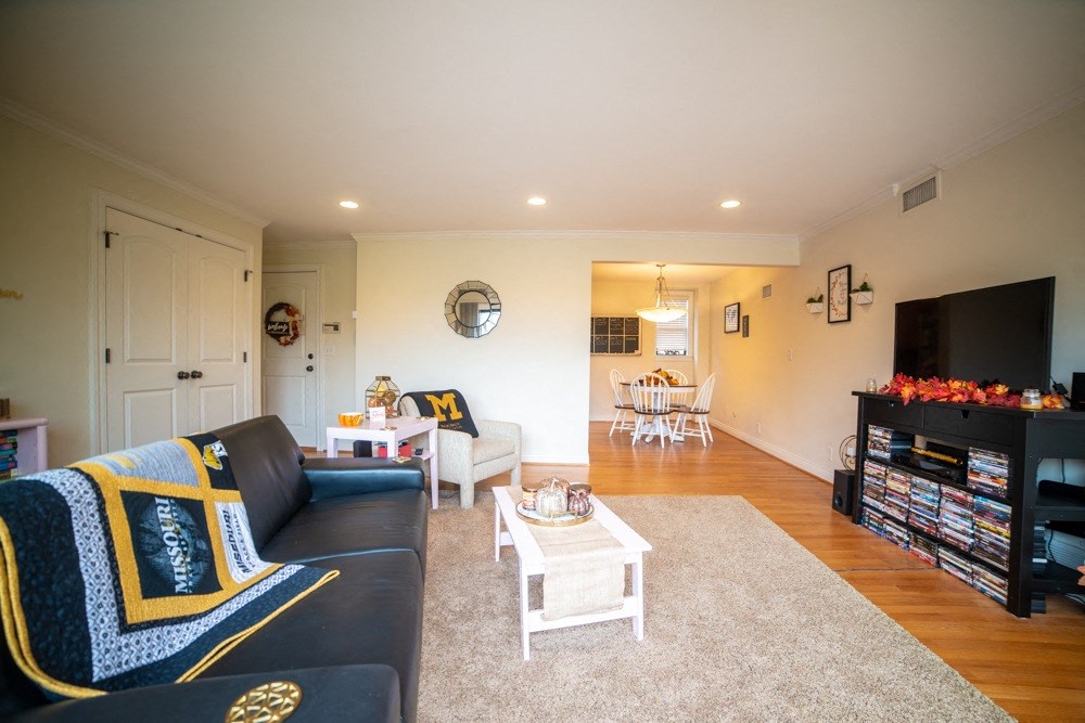 a living room with a couch and a coffee table and a tv