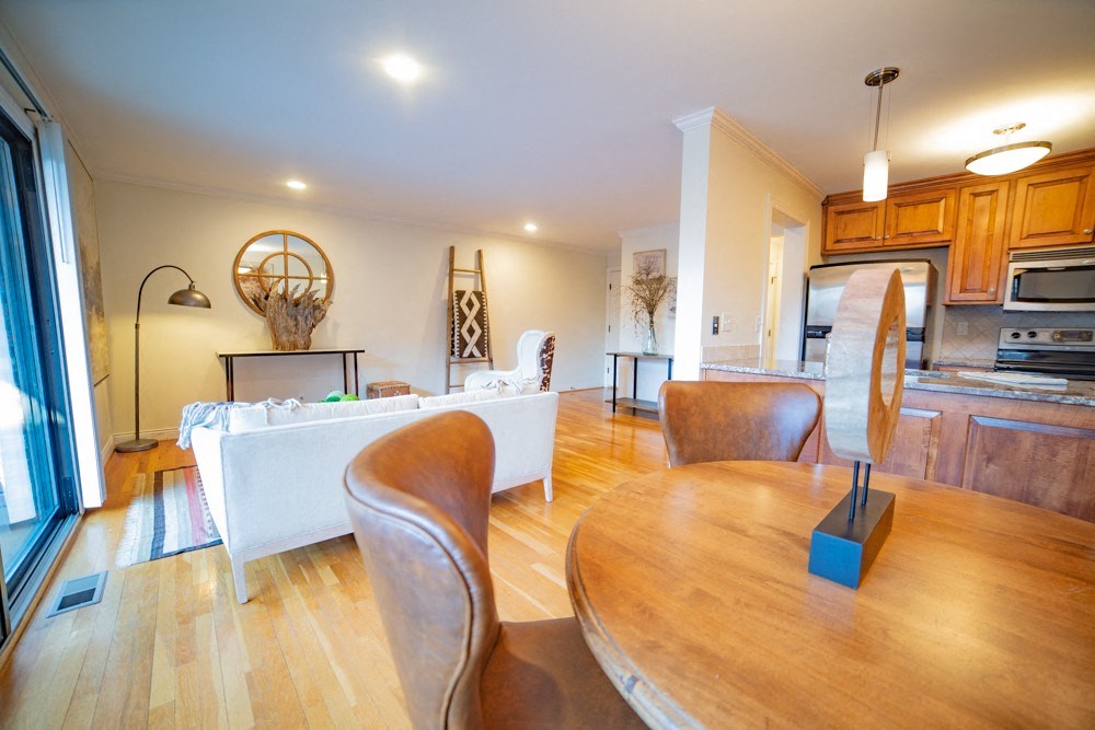 a dining room and living room with a table and chairs