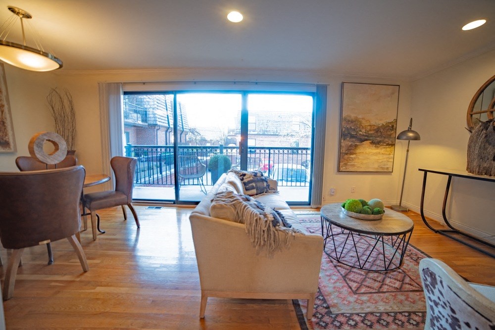 a living room with a sliding glass door to a balcony