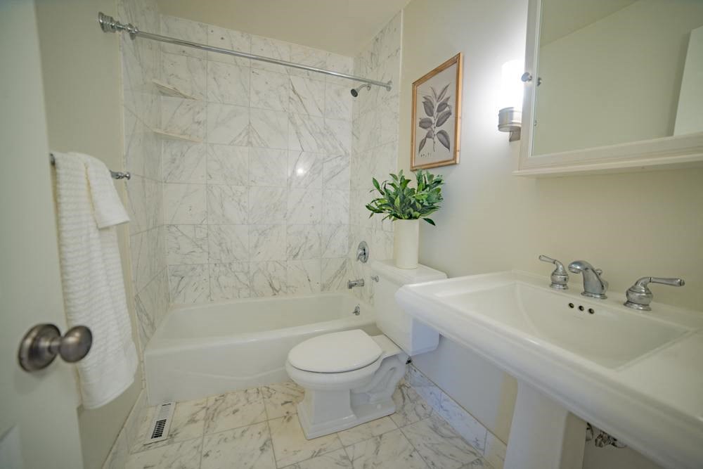 a white bathroom with a toilet and a sink