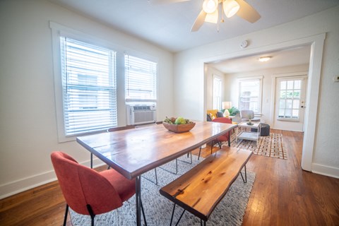 a dining room with a wooden table and chairs