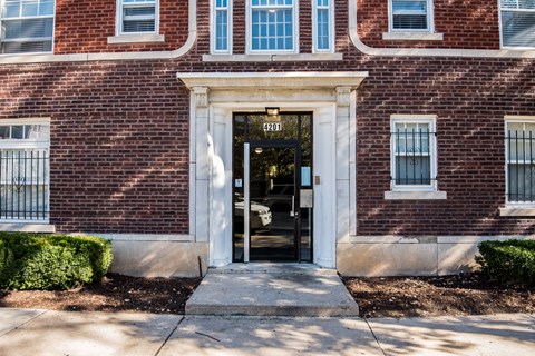 A red brick building with a black door and windows.