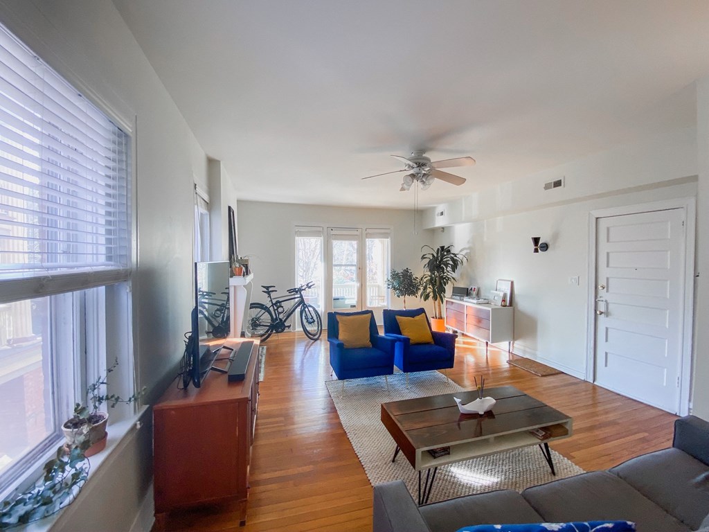 a living room with a ceiling fan and a couch