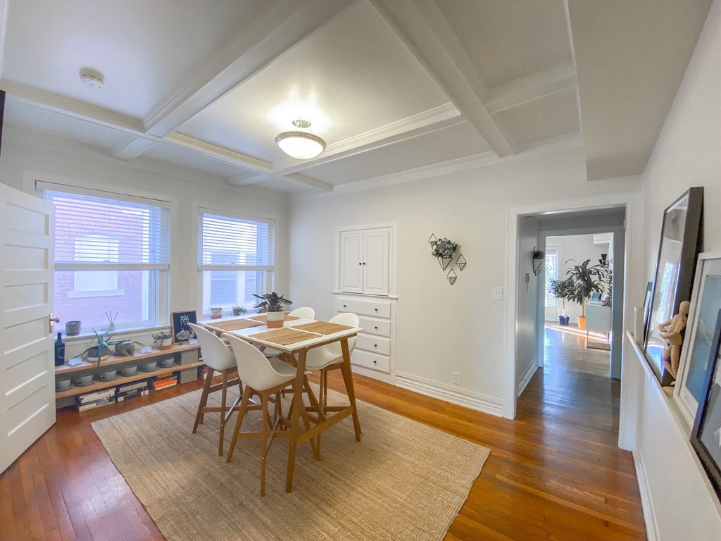 a dining room with a table and chairs and a window
