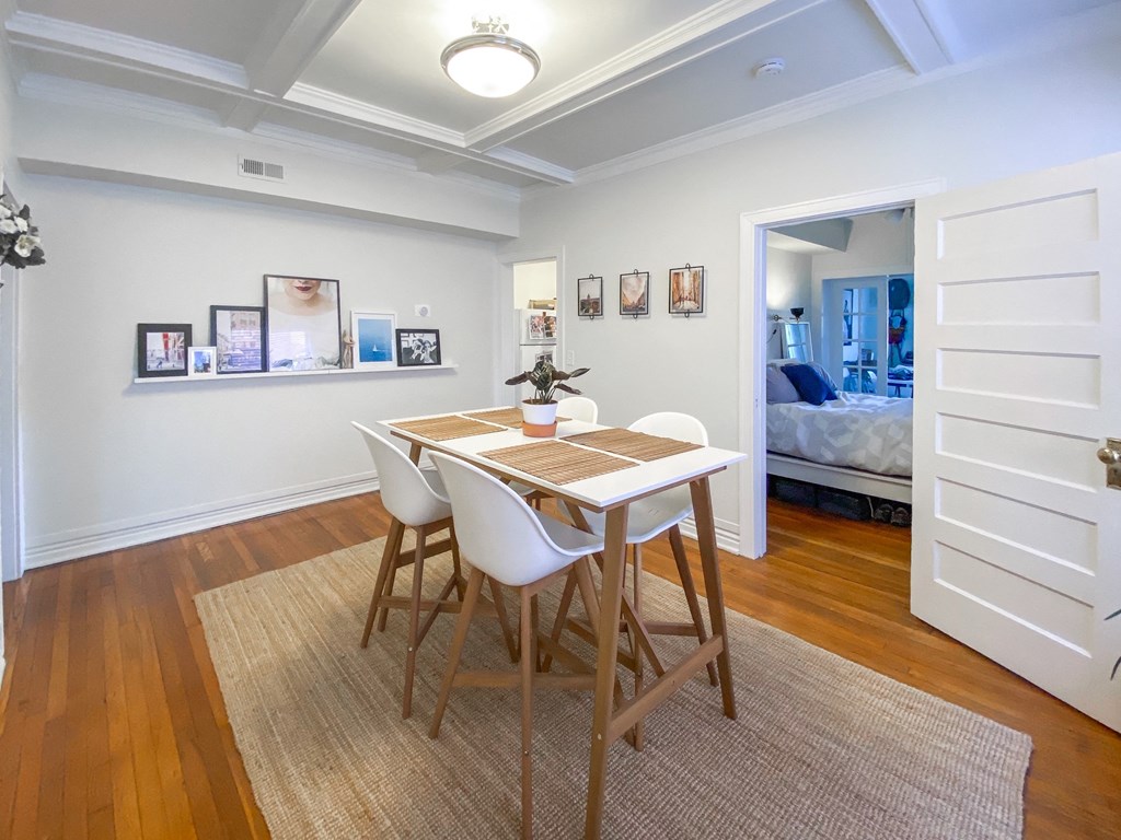a dining room with a table and chairs next to a bedroom
