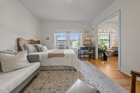 A bedroom with a large bed and a couch.