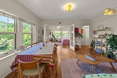 A dining room with a long table and chairs.