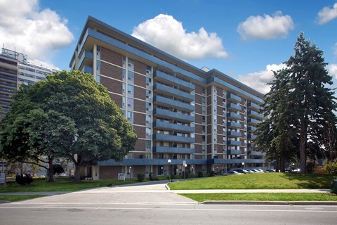 A large building with a parking lot in front.