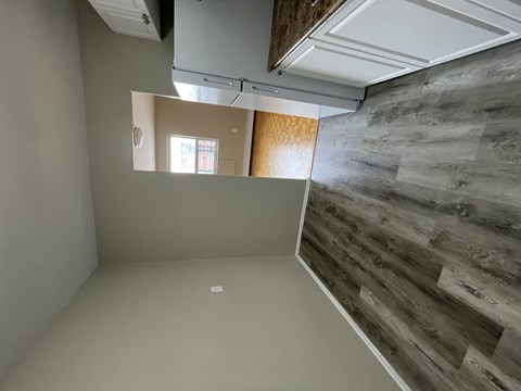 A room with a wooden wall and a white ceiling.