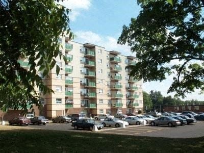 a parking lot with cars parked in front of an apartment building