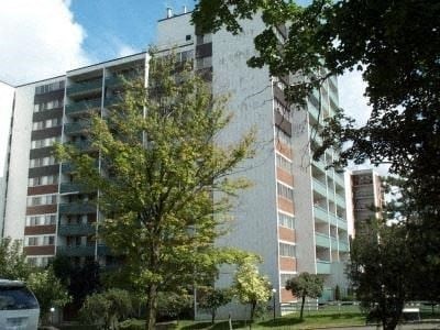 a large building with a tree in front of it