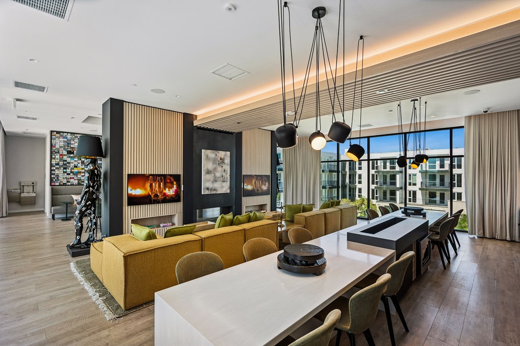 A modern living room with a white dining table and yellow and brown sofas.