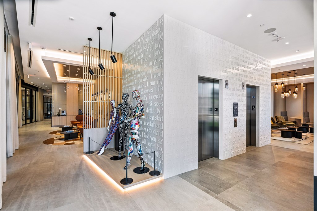 A modern hallway with a sculpture in the middle.