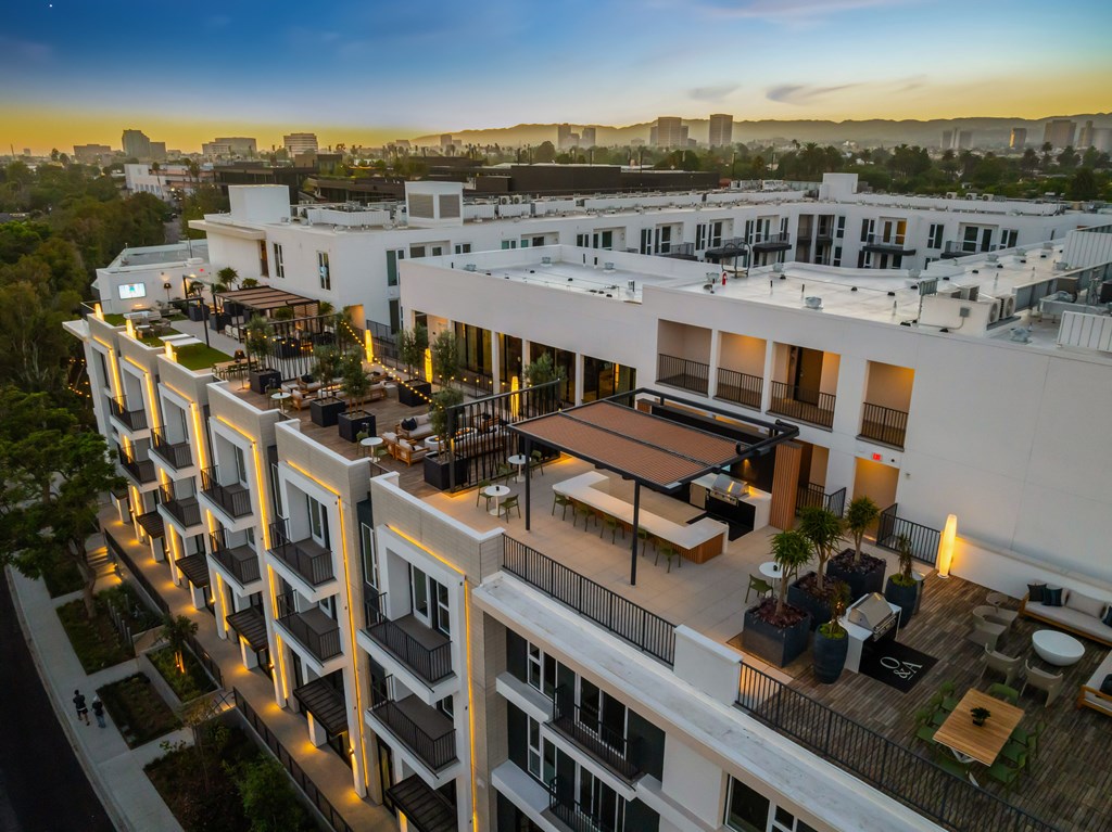 A modern apartment complex with balconies and outdoor seating areas.