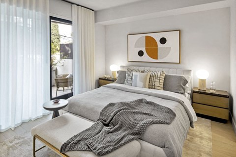 a bedroom with a bed and a sliding glass door