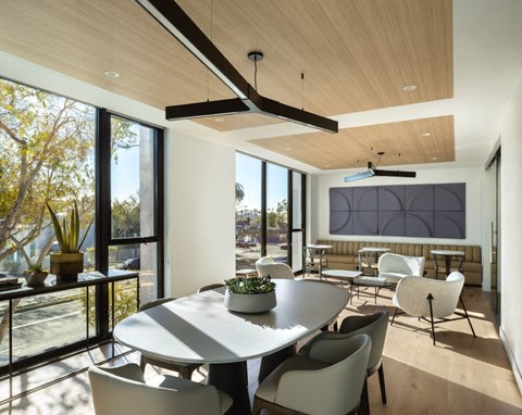 a dining room with a white table and chairs