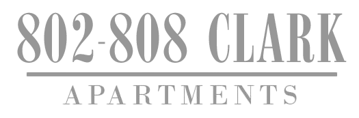 The image shows a sign for 802-808 Clark Apartments.
