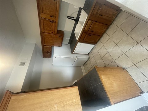 an overhead view of a kitchen with wooden cabinets and a sink