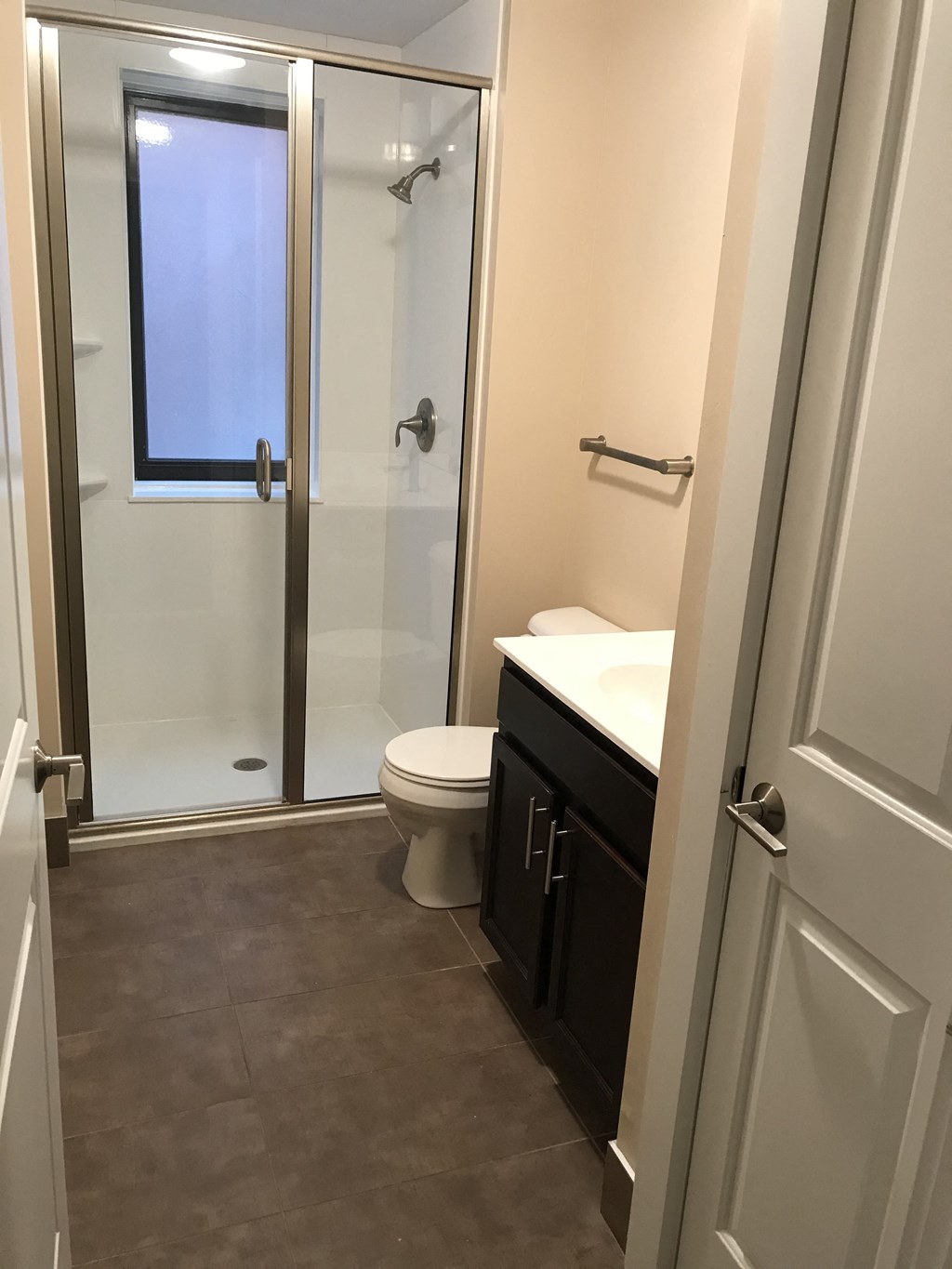 a small bathroom with a shower toilet and sink