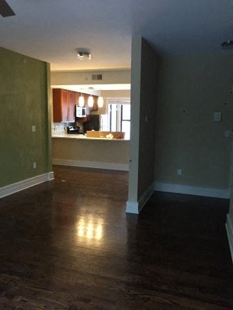 an empty living room with a hard wood floor