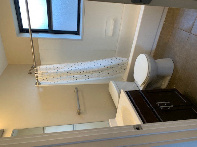 a bathroom with a shower and a toilet and a sink