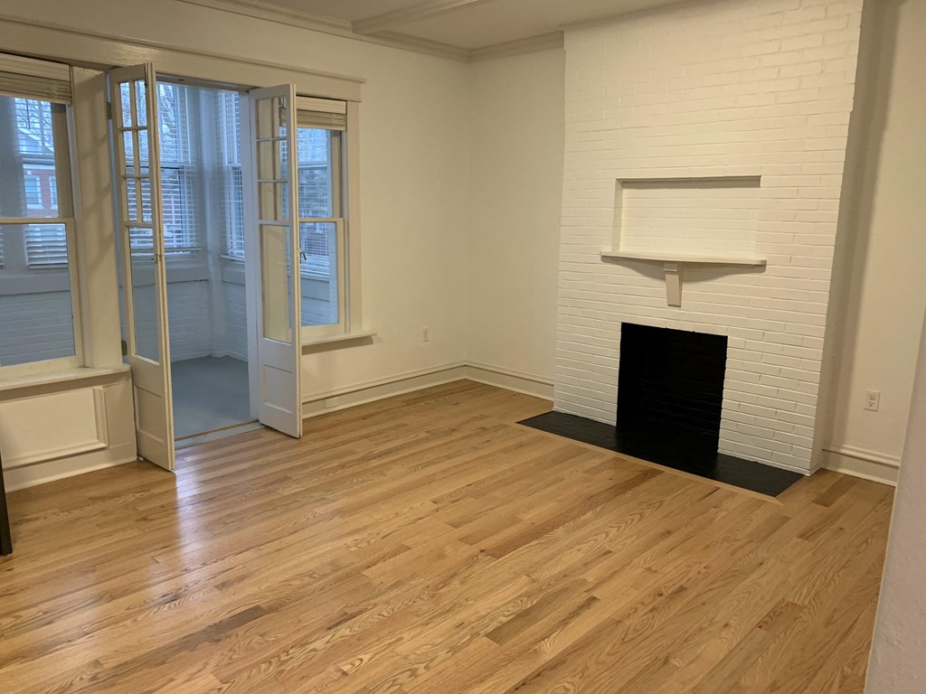 a living room with wood flooring and a fireplace