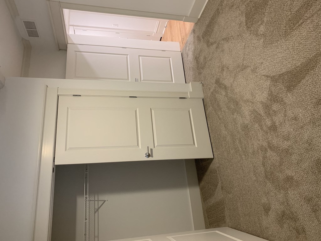 an overhead view of a bathroom with white cabinets