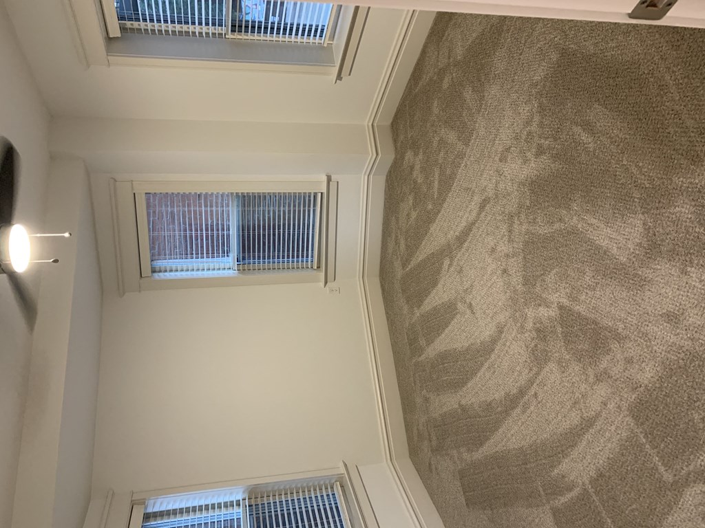 the view from the top of a stairwell looking down into a room with windows