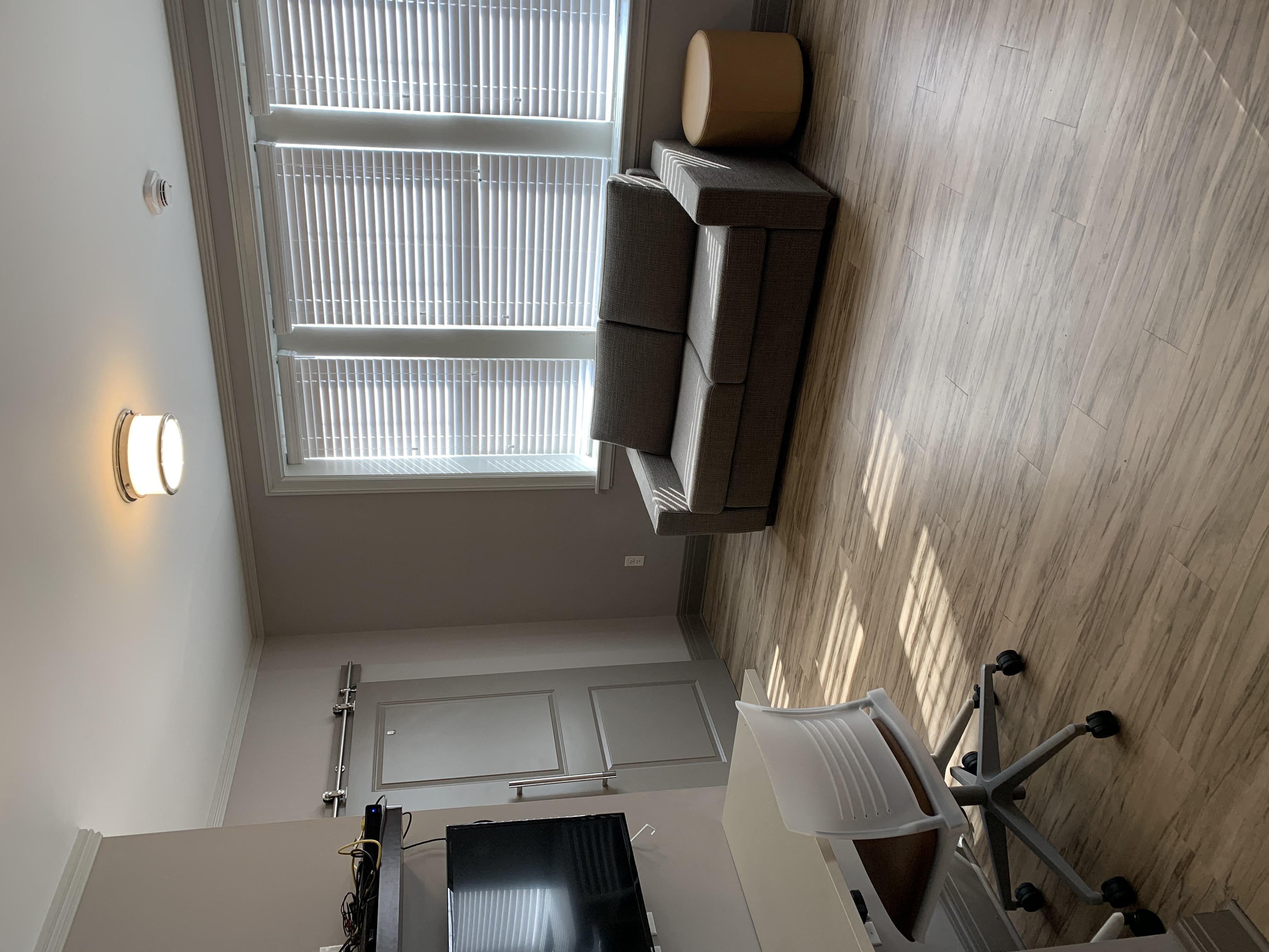 a small office with a desk and a window